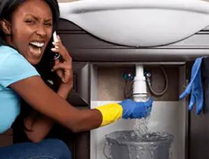 Emergency plumbing repair for a leaking sink drain under a bathroom vanity in Salt Lake City, UT