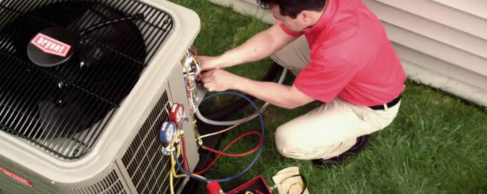 HVAC technician servicing an outdoor air conditioner unit in Salt Lake City, UT