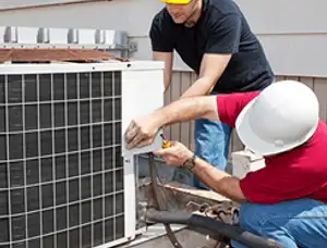 HVAC technicians repairing an outdoor AC unit on a rooftop in Salt Lake City, UT